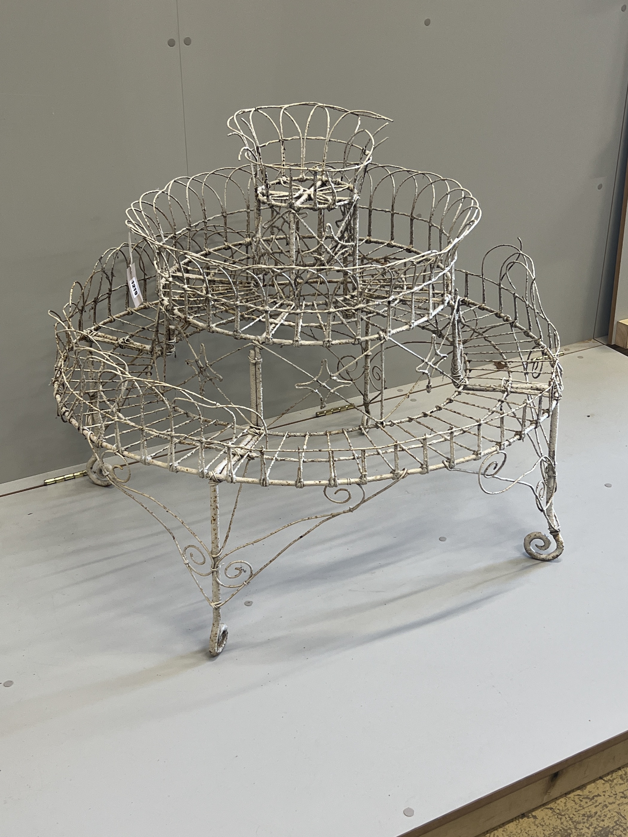 A Victorian painted wirework circular three tier pot stand, diameter 94cm, height 81cm